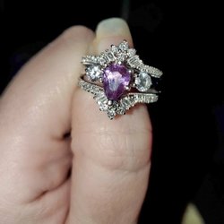 My son designed this ring for my daughter-in-law. It is white gold, purple sapphire. If it shows up at your shop, please contact me!