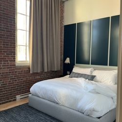The Skowhegan by Kasa - King bedroom. With a door and large tv