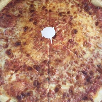 Slices Of Brooklyn - a cheese pizza on a table - Pizza Near Me - Brooklyn, New York Slices Of Brooklyn - a cheese pizza on a table - Pizza Near Me - Brooklyn, New York