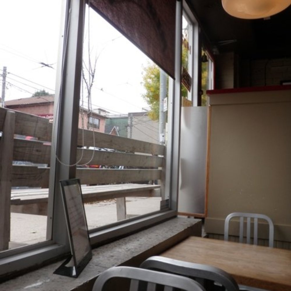 Red Rocket Coffee - a view of a street through a window - Desserts Near Me - Toronto, Ontario Red Rocket Coffee - a view of a street through a window - Desserts Near Me - Toronto, Ontario