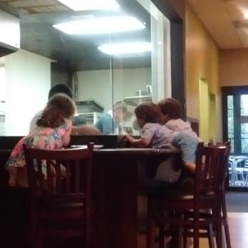 Pizzology - Kids watching the pizza master flip the dough! - Pizza Near Me - Carmel, Indiana