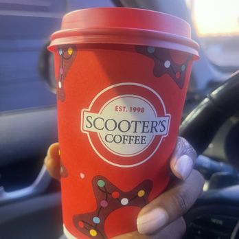 Scooter's Coffee - a hand holding a cup of coffee - Donuts Near Me - Chelsea, Alabama Scooter's Coffee - a hand holding a cup of coffee - Donuts Near Me - Chelsea, Alabama