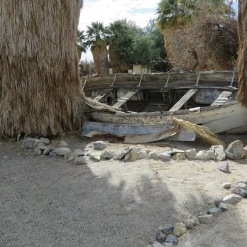 Soda Springs Resort - An old boat against some palm trees. - Landmarks & Historical Buildings Near Me - Baker, California