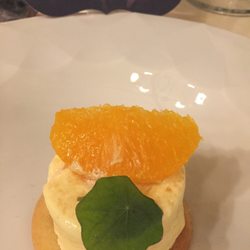Villa Eva - Dessert of a delicate custard with citrus wedges on a shortbread cookie
