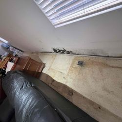 All Hands Restoration - Hidden water damage behind a couch. Undetected leaks can cause serious damage!