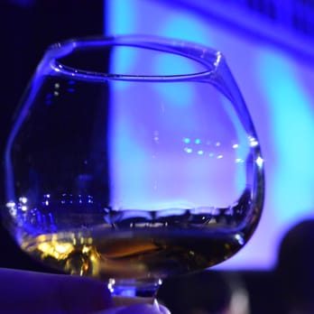 Johnnie Walker - a hand holding a glass of whiskey - Beer, Wine & Spirits Near Me - Los Angeles, California