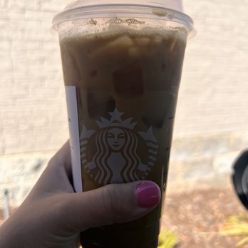Starbucks - a hand holding a cup of iced coffee - Coffee & Tea Near Me - Augusta, Georgia