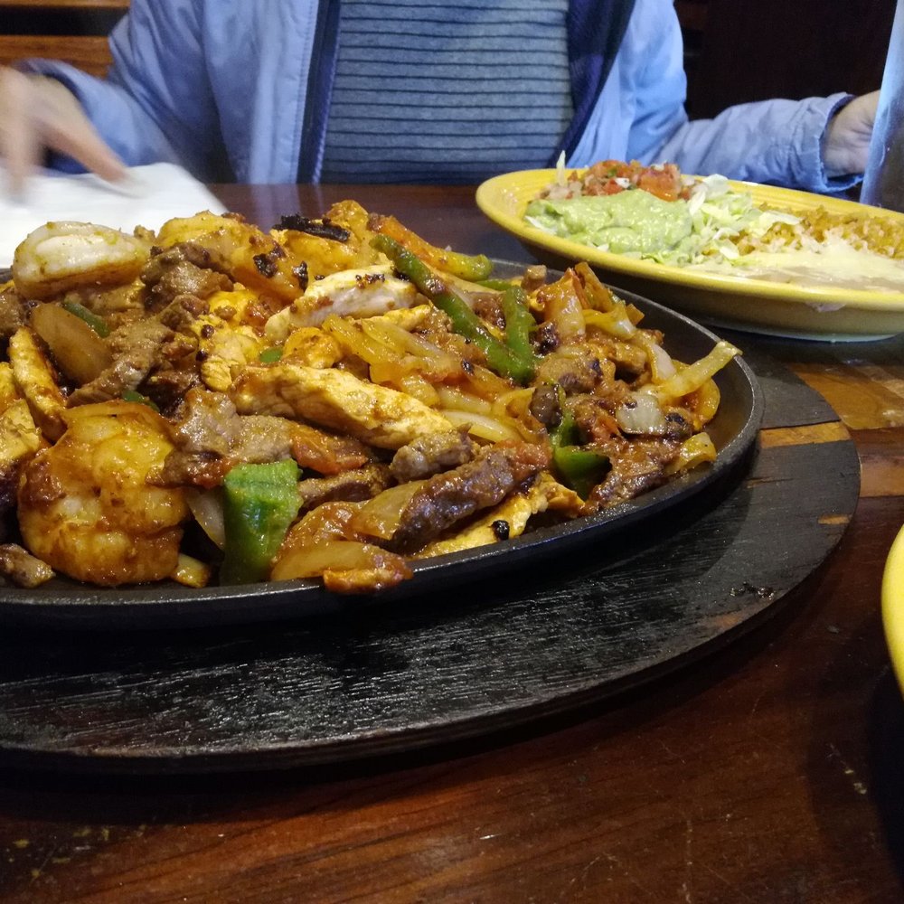 Las Trojas Cantina - Fajitas with shrimp, steak, chicken, onions and bell peppers - Mexican Near Me - Morrow, Georgia Las Trojas Cantina - Fajitas with shrimp, steak, chicken, onions and bell peppers - Mexican Near Me - Morrow, Georgia