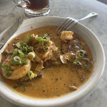 Hank's - Half eaten shrimp and grits. Decadent but so good!! - Coffee & Tea Near Me - Austin, Texas