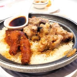 Fancy Chinese Cuisine - Steamed rice in a pot w/ chicken feet & pork ribs. Crisped rice cooked at the pot bottom. Delicious and recommended!