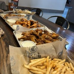 East Coast Wings + Grill - 3 different types of wings, onion rings and fries. 50 Bone In Wings Onion Rings Tray Fry Tray