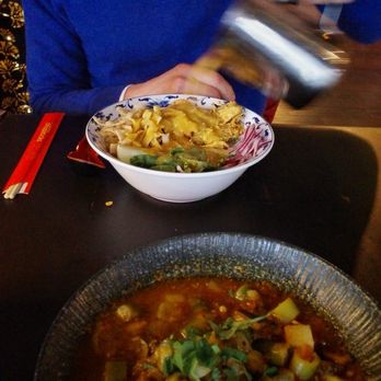 Top Burmese Bistro Royale - Pouring soup broth on Khao Soi - Burmese Near Me - Beaverton, Oregon Top Burmese Bistro Royale - Pouring soup broth on Khao Soi - Burmese Near Me - Beaverton, Oregon