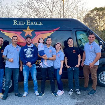 Red Eagle Flooring - a group of people standing in front of a van - Flooring Near Me
