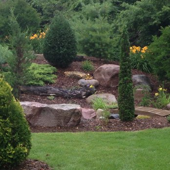 Masterpiece Landscaping - a garden with rocks, shrubs, and flowers - Landscaping Near Me - Minnetonka, Minnesota Masterpiece Landscaping - a garden with rocks, shrubs, and flowers - Landscaping Near Me - Minnetonka, Minnesota