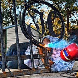 Double R Fencing, Inc. - Our top welder Ferrell working on a custom entrance gate.