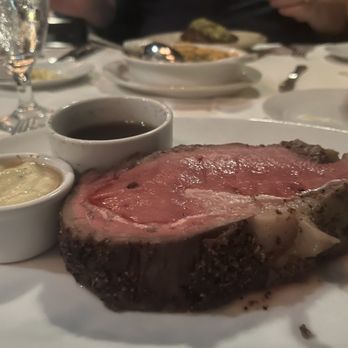 Cavanugh's - a large piece of meat on a plate with dipping sauces - Seafood Near Me - Evansville, Indiana Cavanugh's - a large piece of meat on a plate with dipping sauces - Seafood Near Me - Evansville, Indiana