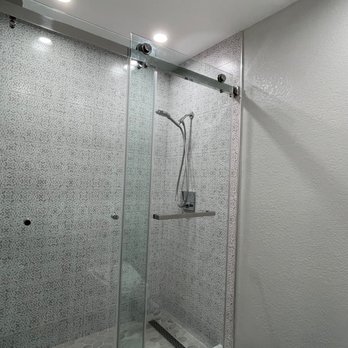 Tam's General Construction - a bathroom with a glass shower - General Contractors Near Me