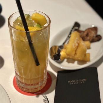 Fogo de Chão - a drink and a plate of food - Brazilian Near Me - Irving, Texas