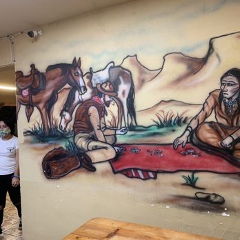 Wild West Cowboy Steakhouse - a woman sitting in front of a mural - Steakhouses Near Me - Buckeye, Arizona Wild West Cowboy Steakhouse - a woman sitting in front of a mural - Steakhouses Near Me - Buckeye, Arizona