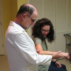Dr. Thompson evaluating an injured elbow