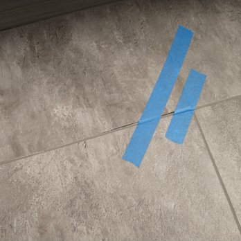 Huber Enterprises - Loose floor tile - not straight, not enough adhesive - General Contractors Near Me - Cedar Rapids, Iowa Huber Enterprises - Loose floor tile - not straight, not enough adhesive - General Contractors Near Me - Cedar Rapids, Iowa
