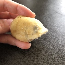 The end of a breadstick with two moldy spots.
