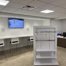 Jeff Wyler Hyundai of Beavercreek - Customer lounge tech bar and coat rack.