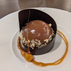 American Harvest - Hazelnut and chocolate mousse dessert, encircled by a chocolate ring and gooey caramel.