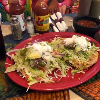 La Parada - There's a tostada under there somewhere I swear! Veggie Tostadas topped with avocado, onions and other goodies. - Mexican Near Me - Indianapolis, Indiana