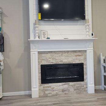 417 Floors - a living room with a fireplace and a flat screen tv - Flooring Near Me