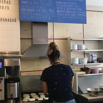 Pomarosa Coffee Shop & Kitchen - Arepas menu and on the grill. This gal was amazingly kind, informative and absolutely lovely to chat with!!! - Venezuelan Near Me - Toronto, Ontario