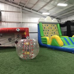 Kickmaster Athletic And Event Center - Soccer goal and inflatable climbing wall and slide.