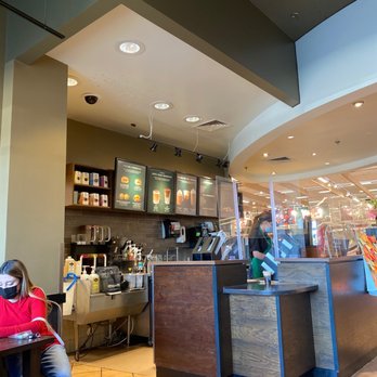 Starbucks - a woman sitting at a table in a coffee shop - Coffee & Tea Near Me - Watauga, Texas Starbucks - a woman sitting at a table in a coffee shop - Coffee & Tea Near Me - Watauga, Texas