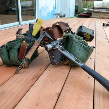 Bee Vera Construction - a tool bag and a hammer on a wooden deck - General Contractors Near Me Bee Vera Construction - a tool bag and a hammer on a wooden deck - General Contractors Near Me