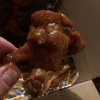 Duckies' Bar & Grill -  hand holding a piece of fried chicken - Bars Near Me - Piedmont, West Virginia