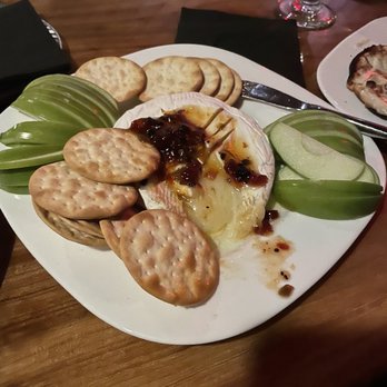 Patio Dolcetto - Warmed Brie, with tomato bacon jam and apple slices. - Wine Bars Near Me - San Marcos, Texas Patio Dolcetto - Warmed Brie, with tomato bacon jam and apple slices. - Wine Bars Near Me - San Marcos, Texas
