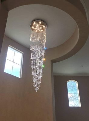 Chandeliers - foyer chandelier installation. every crystal strand hung individually Chandeliers - foyer chandelier installation. every crystal strand hung individually