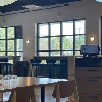 ROCO Kitchen & Coffee - Stools overlooking the parking lot and outdoor seating. - Coffee & Tea Near Me - Columbia, Maryland