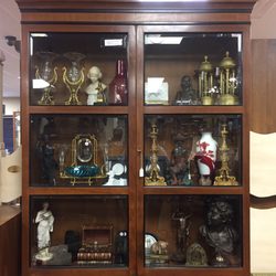 Vintage Baker Bookcase filled with French vases, doré bronze candlesticks, tantalus, bronze busts, Baccarat, English antiques, and more.