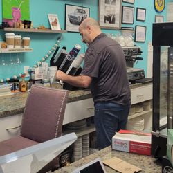 Locos x Argentina - The owner making a cappuccino.