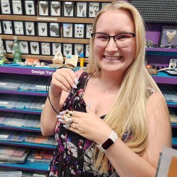 Shark Frenzy - Owner Brittanie after making my new necklace from her Magladon tooth she sold me!  I will cherish forever!  Thank you! - Souvenir Shops Near Me - Venice, Florida