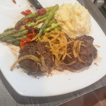 Laura's Bar And Grill - Steak tips with mashed potatoes and asparagus Salad topped - American Near Me - Smithfield, Rhode Island