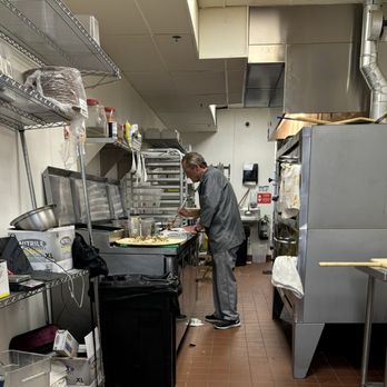 Dough Daddy's Pizza - a man in a commercial kitchen - Pizza Near Me - Westmont, Illinois Dough Daddy's Pizza - a man in a commercial kitchen - Pizza Near Me - Westmont, Illinois