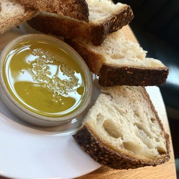 Willmott's Ghost - Colin's sourdough bread with olive oil - Italian Near Me - Seattle, Washington Willmott's Ghost - Colin's sourdough bread with olive oil - Italian Near Me - Seattle, Washington