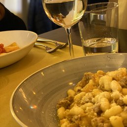 Special of the day Gnocchi with pumpkin and meat and a glass of white wine. Special of the day Gnocchi with pumpkin and meat and a glass of white wine.