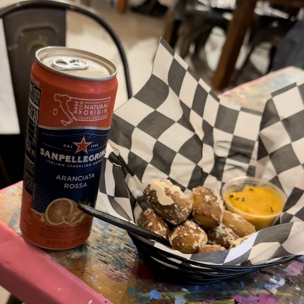 San Pellegrino (left) and pretzel bites with cheese sauce (right) San Pellegrino (left) and pretzel bites with cheese sauce (right)