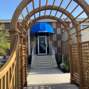 Seaglass - the entrance to a building with a blue umbrella - Wine Bars Near Me - Jacksonville, Florida Seaglass - the entrance to a building with a blue umbrella - Wine Bars Near Me - Jacksonville, Florida