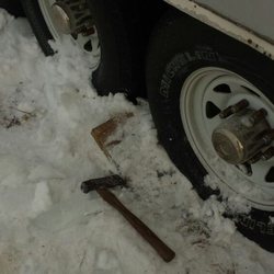 Price Mobile RV Service & Repair - Trailer frozen to the ground. If your going North in the Winter park on wood. Chipping your RV out of an ice block isn't a good time.