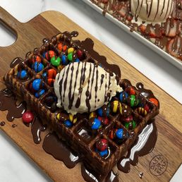 Waffle, Milk Chocolate Drizzle, M&M Topping, & a scoop of Vanilla. Crepe, Milk Chocolate Drizzle, Strawberry Topping, & a scoop of Vanilla. Waffle, Milk Chocolate Drizzle, M&M Topping, & a scoop of Vanilla. Crepe, Milk Chocolate Drizzle, Strawberry Topping, & a scoop of Vanilla.