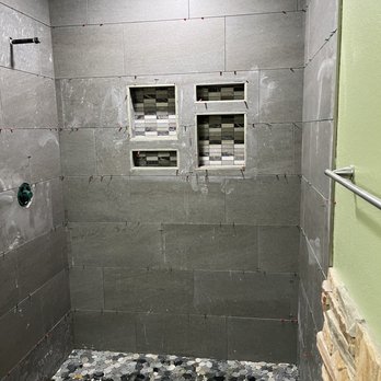 Stroy - Pebble stone floor mosaic with double soap niches and Gray 12x24 wall tiles. - General Contractors Near Me - Rio Linda, California Stroy - Pebble stone floor mosaic with double soap niches and Gray 12x24 wall tiles. - General Contractors Near Me - Rio Linda, California